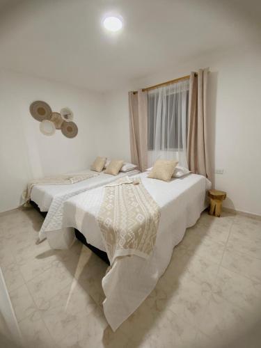 a bedroom with two beds and a window at Casa Verbena in Cisneros