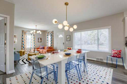 a kitchen and living room with a table and chairs at UNL Retreat Eclectic 5bd 5mins to Downtown in Lincoln