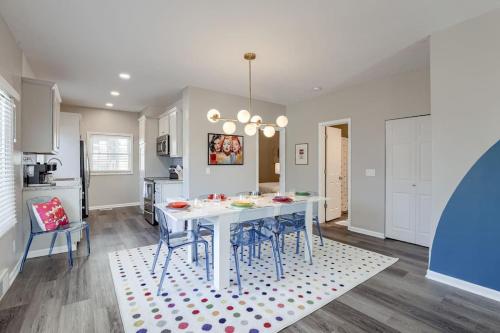 a kitchen and dining room with a white table and chairs at UNL Retreat Eclectic 5bd 5mins to Downtown in Lincoln
