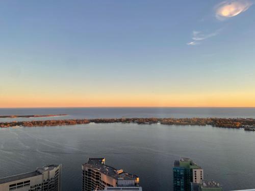 an aerial view of a large body of water with buildings at Presidential Suite Heart of Downtown with Stunning View in Toronto