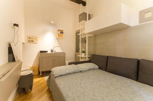a living room with a couch and a table at Biciclò Mini Studio in Ferrara