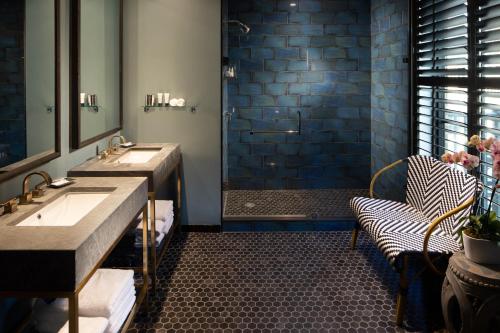 a bathroom with two sinks and a shower at Hotel ZaZa Austin in Austin