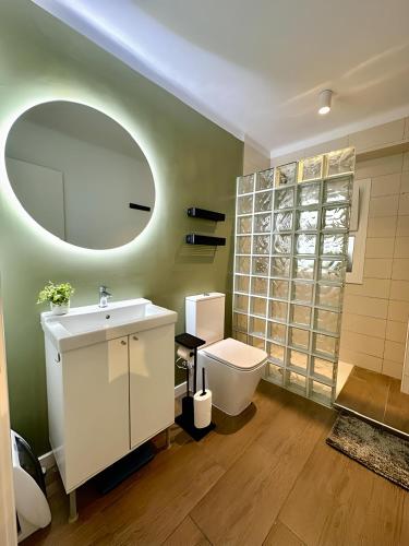 a bathroom with a sink and a toilet and a mirror at Edf. 4 caminos in Nerja