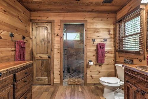 a log cabin bathroom with a toilet and a shower at Mtn View•Hot Tub•Firepit•Game Rm•10min to Blue Ridge in Morganton