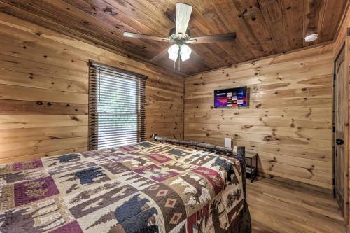 a bedroom with a bed and a ceiling fan at Mtn View•Hot Tub•Firepit•Game Rm•10min to Blue Ridge in Morganton