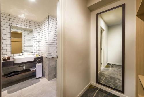 a bathroom with a sink and a mirror at Hilton Garden Inn Kuala Lumpur - North in Kuala Lumpur