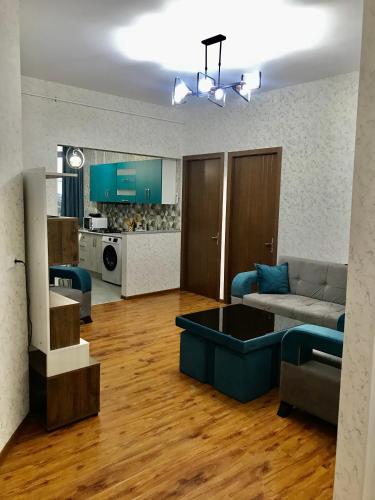 a living room with a couch and a kitchen at Best choice in Kutaisi