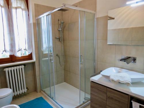 a bathroom with a shower and a sink at Villa Anastasye Your Lakefront Vacation Rental in Predore