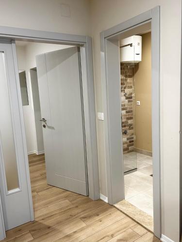 an empty room with a door and a mirror at Urban Residence Apartments in Mostar