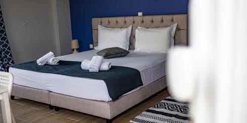 a bedroom with a bed with towels on it at Nikitas Apartments & Suites in Kanali