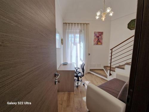 a door leading to a room with a bed and a desk at Palazzo Pisano Sorso-Tourist Rental in Sorso