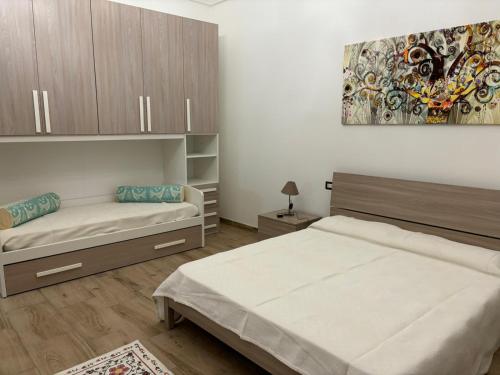 Säng eller sängar i ett rum på Palazzo Pisano Sorso-Tourist Rental