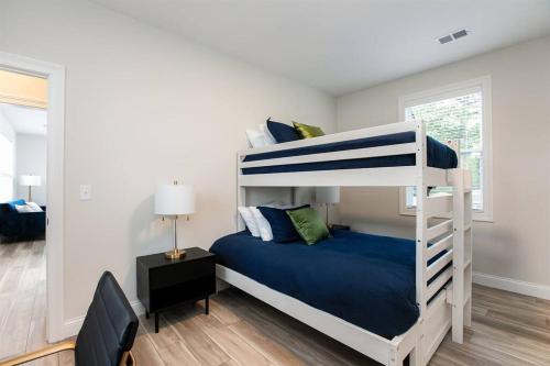 a bedroom with a bunk bed with blue sheets at Victory Views Estate: Luxury Guest Loft in South Bend