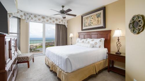 a bedroom with a bed and a large window at Ariel Dunes II 1701 in Destin
