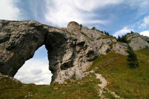 a large rock formation on a grassy hill at Jánsky rezort in Liptovský Ján