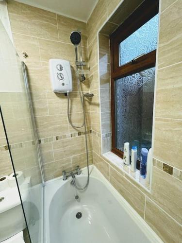 a bathroom with a shower and a bath tub at SwankyHome4Groups/Contractors/M5 in Dudley