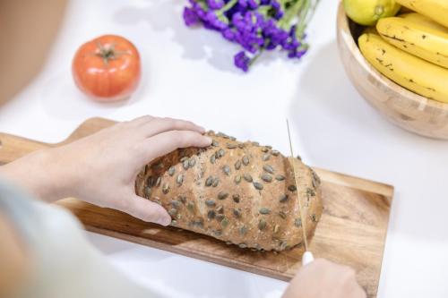 a person holding a loaf of bread on a cutting board at La Cochera Casa Emblemática en Santa Cruz de Tenerife in Santa Cruz de Tenerife