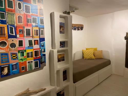 a room with a couch in front of a painting at Vezzhouse con Convenzione per Spa & Wellness in Vezzano Ligure