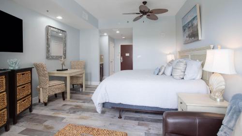 a bedroom with a bed and a desk and a couch at Luau II 7021 Studio in Destin