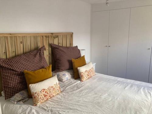 a bed with a bunch of pillows on it at Ideal apartamento con terraza en Bernabeu in Madrid