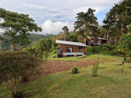 a house in the middle of a yard at The Lodge at Reventazon River Mountain Ranch in Turrialba