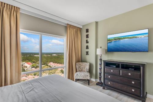 a bedroom with a large bed and a large window at Luau I 7907 in Destin