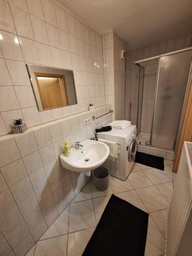 a bathroom with a toilet and a sink and a shower at FeWo BlackForest in Neuenburg am Rhein