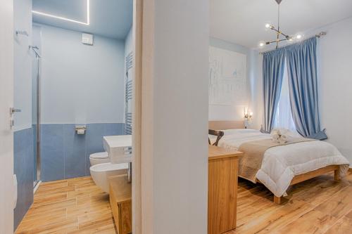 a bedroom with a bed and a bathroom with a sink at Le Canterine di Peppe in Ascoli Piceno
