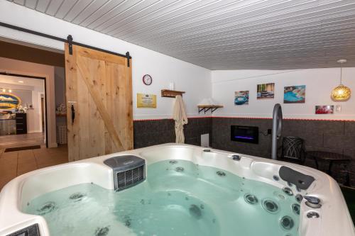 een jacuzzi in een kamer met een houten deur bij RiverWalk Inn in Pagosa Springs