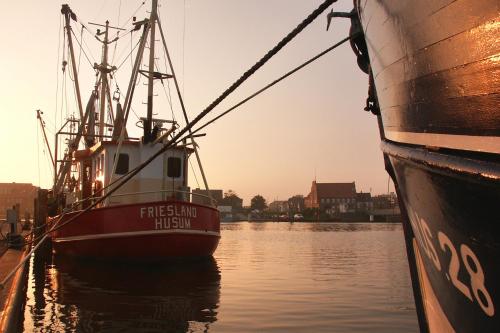 a boat is docked next to another boat in the water at Best Western Plus Theodor Storm Hotel in Husum
