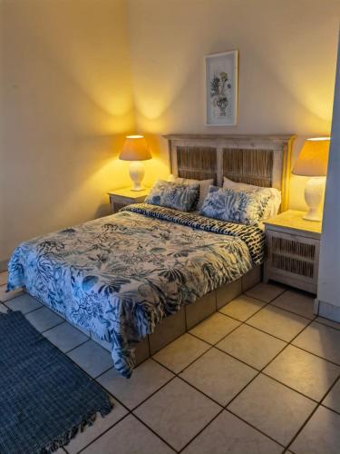 a bedroom with a bed and two night stands at Seaside, Marina Beach in Marina Beach