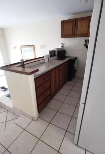 a kitchen with a counter top in a room at Seaside, Marina Beach in Marina Beach