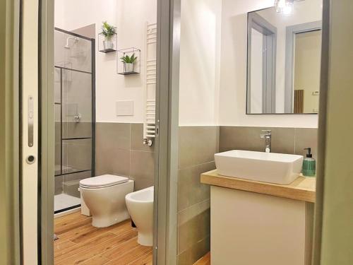 a bathroom with a sink and a toilet and a mirror at Brand New Panoramic Apartment in Vitinia