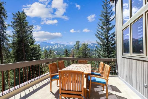 a table and chairs on a balcony with a view of mountains at Bear Peak Lodge 1 Mile to Gondola and Great Views in Breckenridge