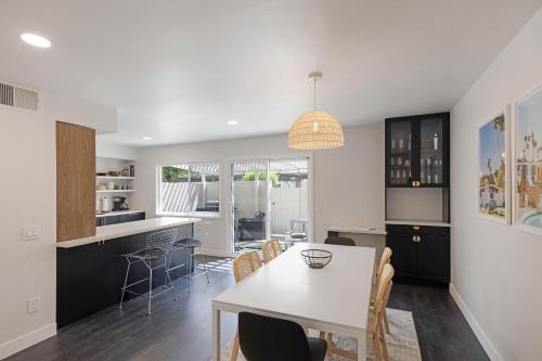 a kitchen and dining room with a table and chairs at \\Golf and Couples Oasis// Midcentury w/6 Pools Hot Tub in Palm Springs