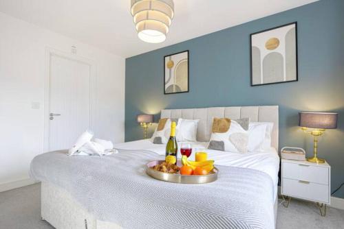 a bedroom with a bed with a tray of fruit on it at Glebe House - 5 Bedroom 3.5 Bathroom - Sleeps 10 - Driveway Parking, Fast Wifi, SmartTVs with SkyTV, Xbox and Netflix by Yoko Property in Milton Keynes