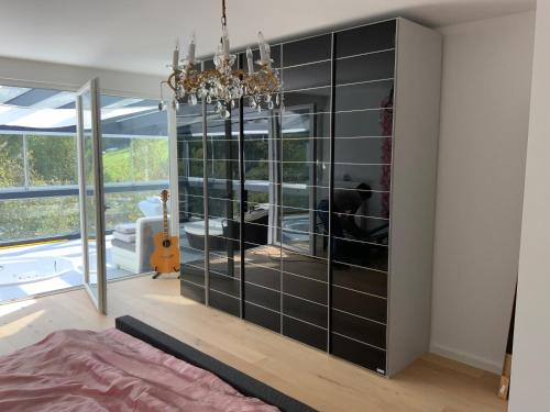 a living room with a large black cabinet at Eifelloft&Spa in Adenau