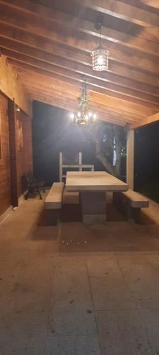 a picnic table in a room with a chandelier at Quinta Alvaredo in Melgaço