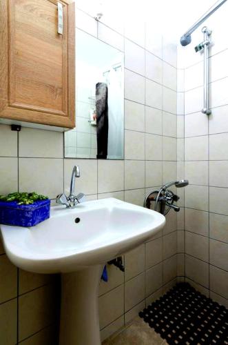 a bathroom with a white sink and a mirror at Vacation_Studio_near_the_beach in Prasás