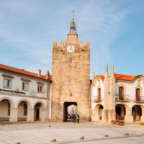 a large brick building with a clock tower at Arca Nova Guest House - Caminha in Caminha