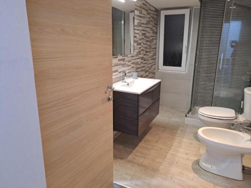 a bathroom with a sink and a toilet at House il Quadrifoglio Airport Fontanarossa in Catania