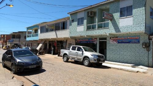 a silver truck parked in front of a building at Pousada do Flávio in Barra de Itabapoana