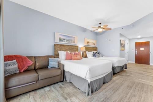 a bedroom with two beds and a couch at Luau II 7026 Studio in Destin