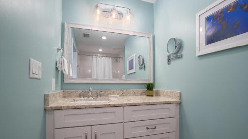 a bathroom with a sink and a mirror at Luau II 7226 Studio in Destin