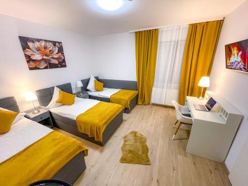 a hotel room with two beds and a desk at Eddy´s Appartment in Magdeburg