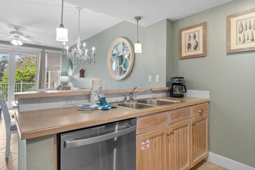 a kitchen with a sink and a dishwasher at Pilot House 412 in Destin