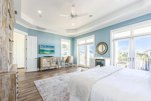 a bedroom with blue walls and a large bed at Slice of Paradise in Destin