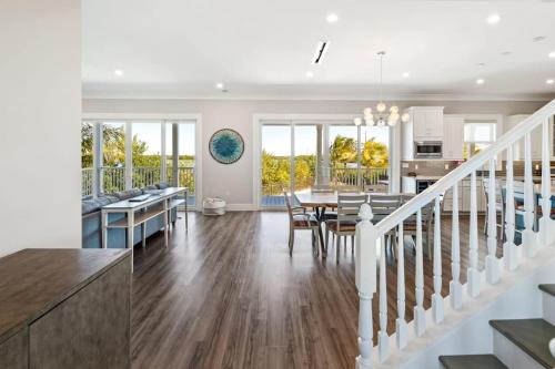 a kitchen and living room with a dining room and a dining table at Spindrift House -Huge Pool, Dock in Stock Island