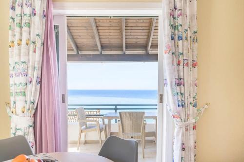 a dining room with a view of the ocean at Amazing Sea View Balcony Ginos Home 123 in Glyfada