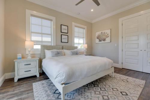 a bedroom with a white bed and a window at Mirador House -Pool & Dock! in Stock Island